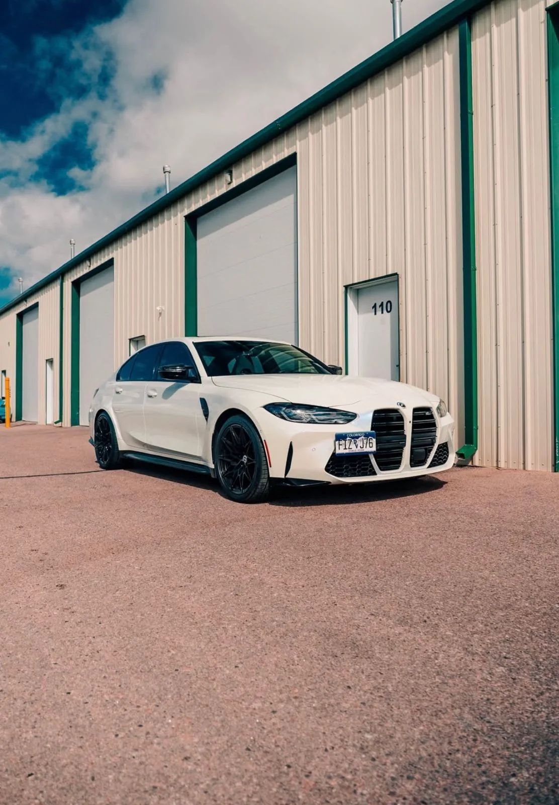 White BMW outside the 719 Auto Customs shop