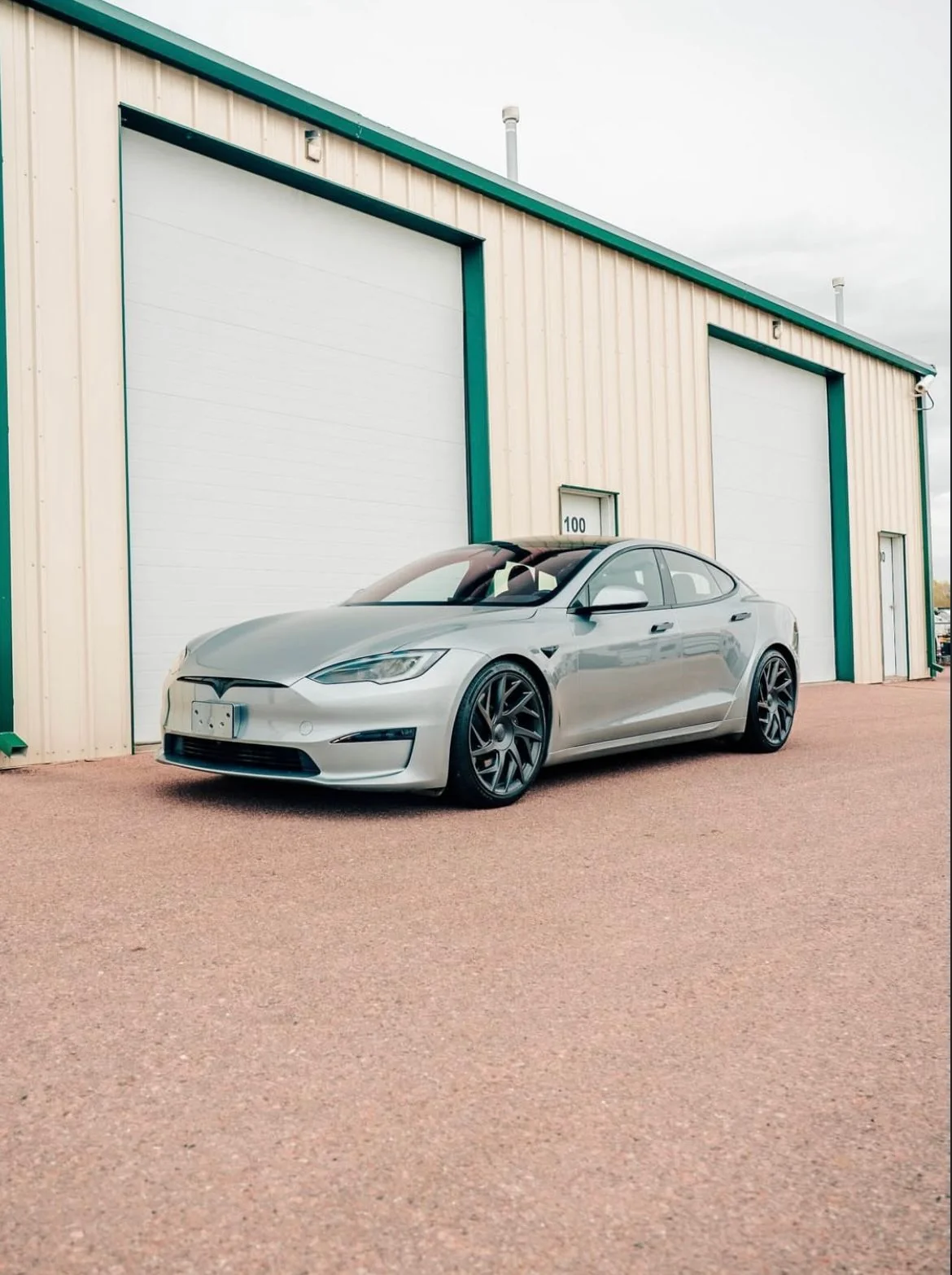 Silver Tesla outside the 719 Auto Customs shop